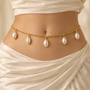 Céleste Pearl-Drop Waist Chain worn over an ivory dress